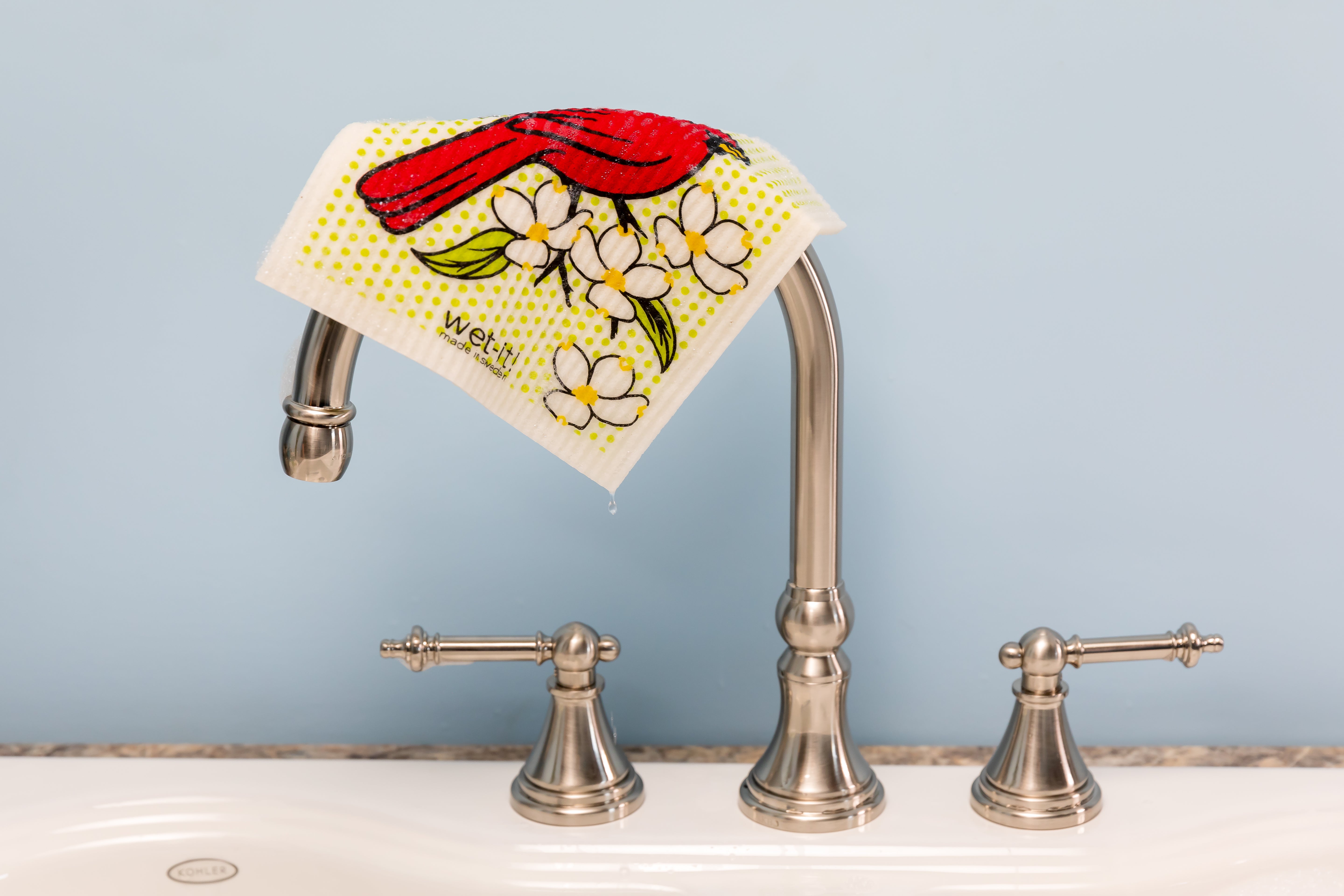 Image of a cardinal wet-it cloth dripping over a faucet